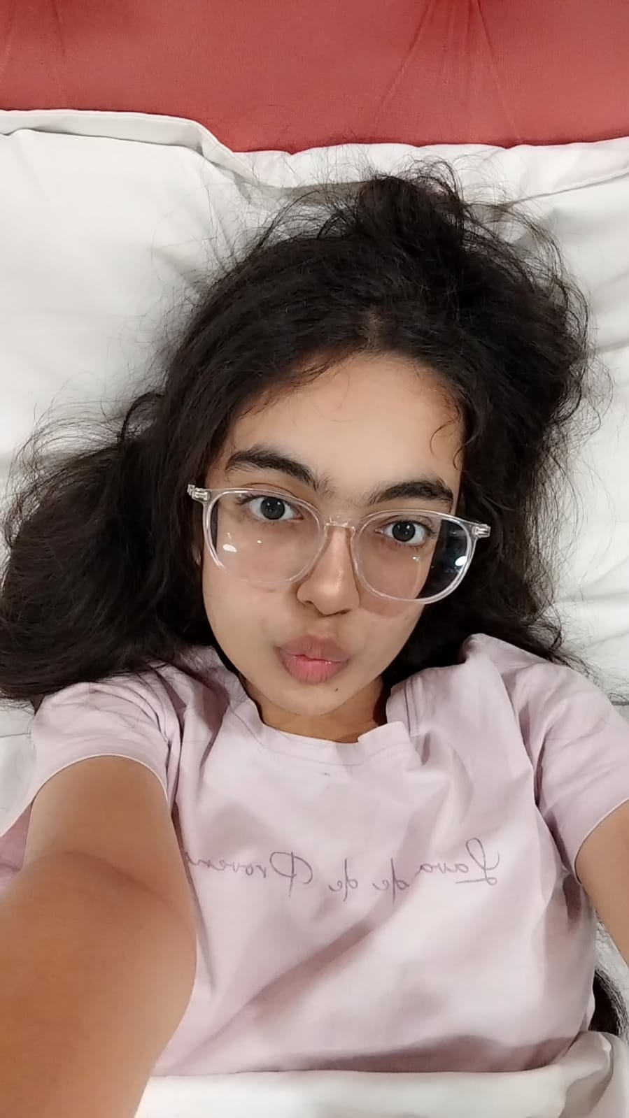 Avni in glasses and a pink shirt