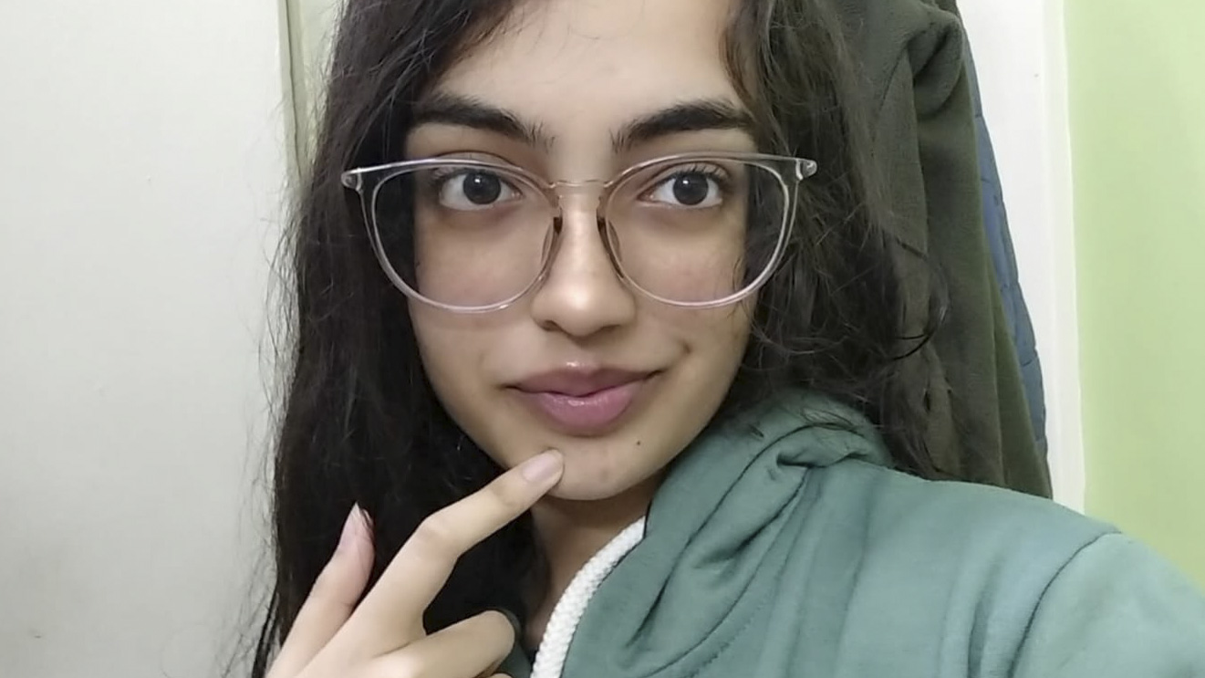 Avni smiling in glasses